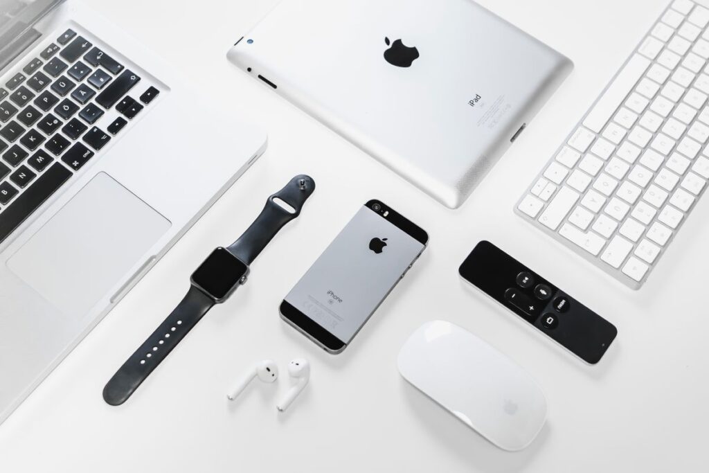 Apple laptop, tablet and phone arranged on a desk