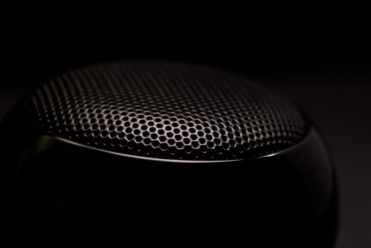 Close-up of a speaker grille in low light